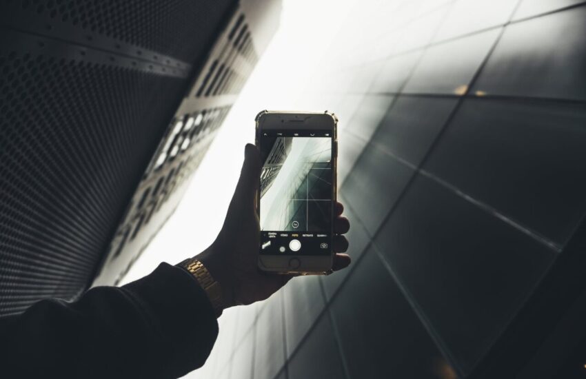 person taking photo of building